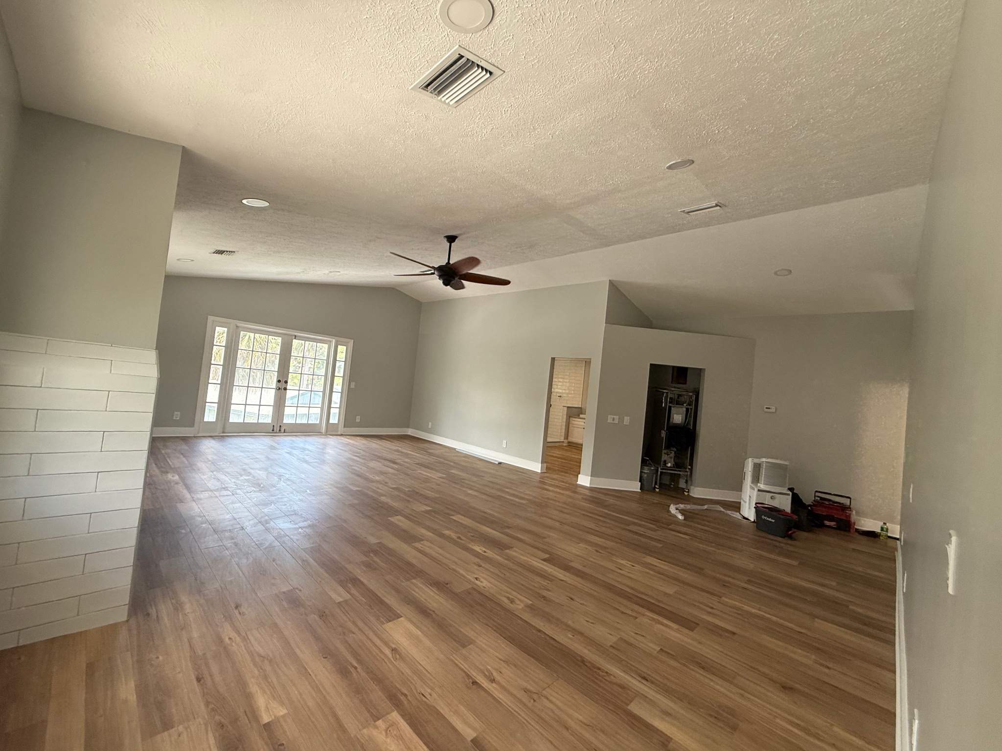 Same living room restored by 3Lotus, new flooring and rebuilt fireplace